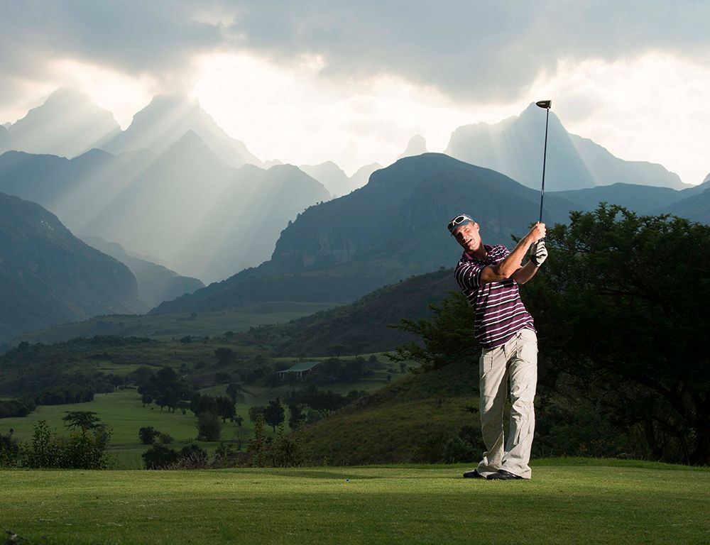 Man hitting a golf ball off the tee